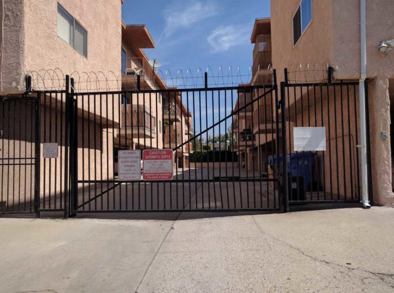 black gate with brown building